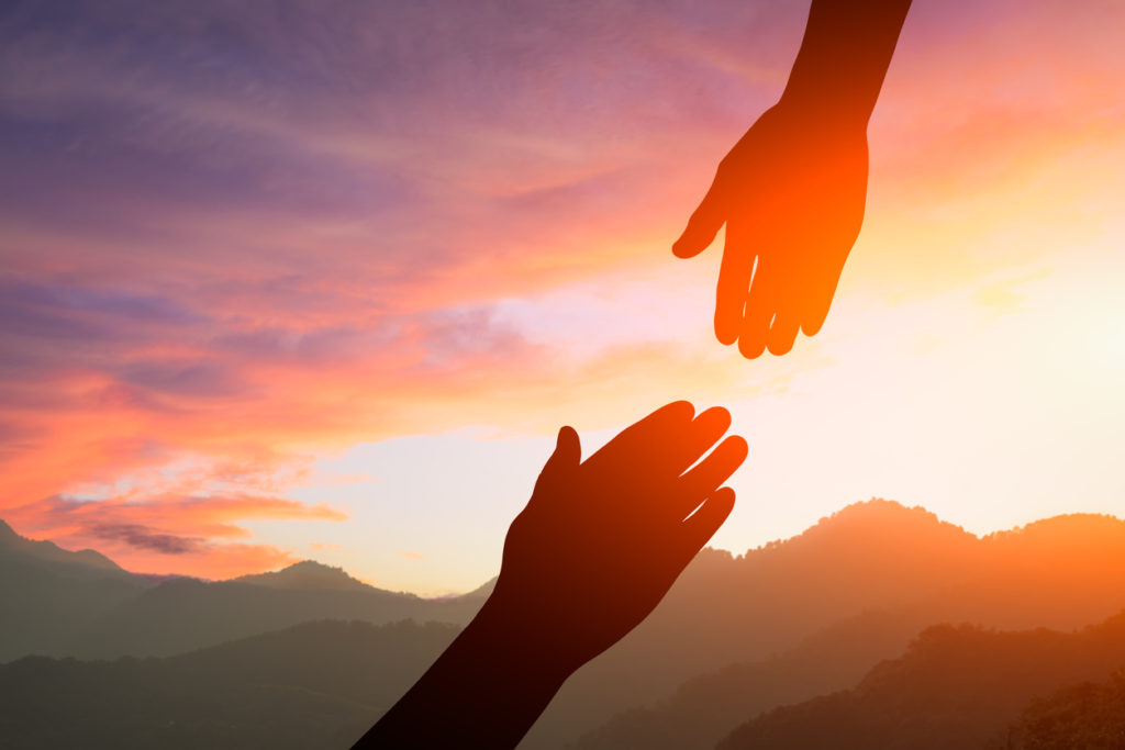 helping hand with the sky sunset background